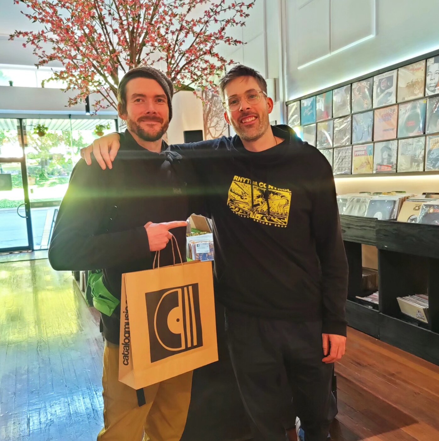 two friends with catalog paper bag